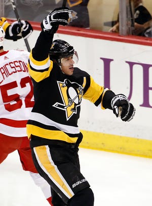 Pittsburgh Penguins’ Evgeni Malkin (71) celebrates his goal in the first period against the Detroit Red Wings in Pittsburgh Saturday. (AP Photo/Gene J. Puskar)
