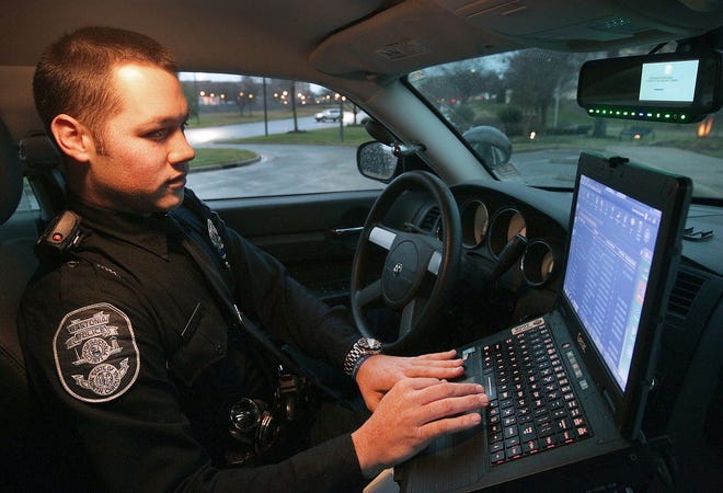 Gastonia Police officer Dylan Rice checks the computer in his patrol car before starting his shift. Rice has been with the department for about a year and a half. [JOHN CLARK/THE GASTON GAZETTE]