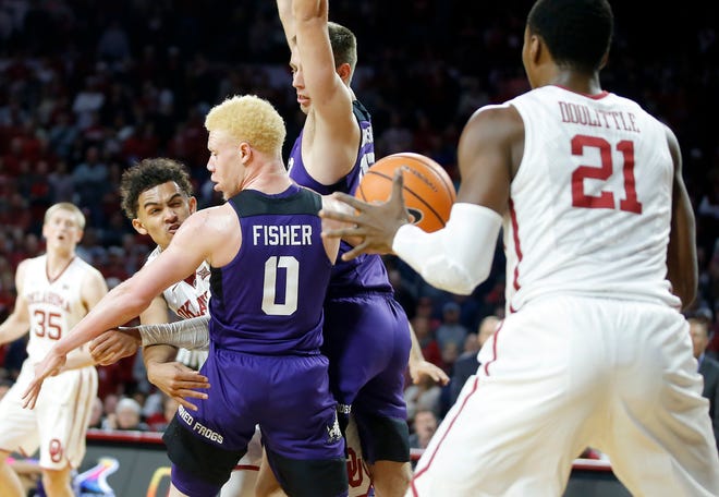 Oklahoma's Trae Young passes the ball to Kristian Doolittle during Saturday's overtime win over TCU at Lloyd Noble Center. Doolittle has come on strong recently as he works his way back into the rotation. [PHOTO BY BRYAN TERRY, THE OKLAHOMAN]