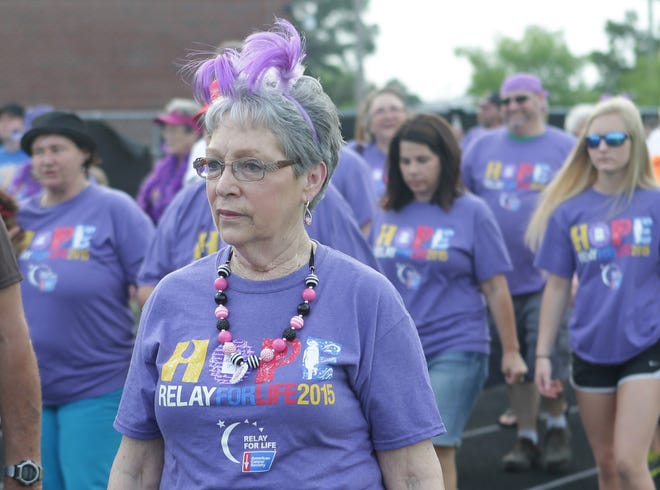Cancer survivors and caregivers are decked out in purple during the survivor lap of the 2015 Relay For Life. Kickoff parties for the Panama City and Panama City Beach chapters are this month. [HEATHER HOWARD/NEWS HERALD FILE PHOTO]
