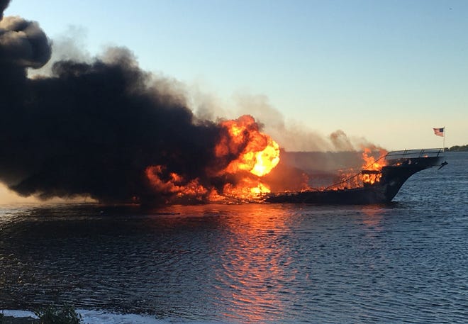 In this photo provided by Pasco County flames engulf a boat Sunday in the Tampa Bay area. The boat ferrying patrons to a casino ship off the Florida Gulf Coast caught fire near shore Sunday afternoon, and dozens of passengers and crew safely made it to land with some jumping overboard to escape, authorities said. [Pasco County Fire Rescue via AP]