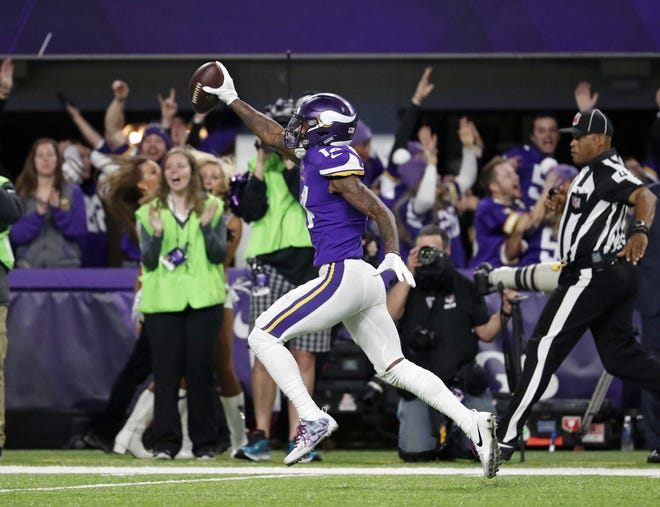 Minnesota Vikings wide receiver Stefon Riggs (14) runs in for a game winning touchdown against the New Orleans Saints during the second half of an NFL divisional football playoff game in Minneapolis. [AP Photo/Jeff Roberson]
