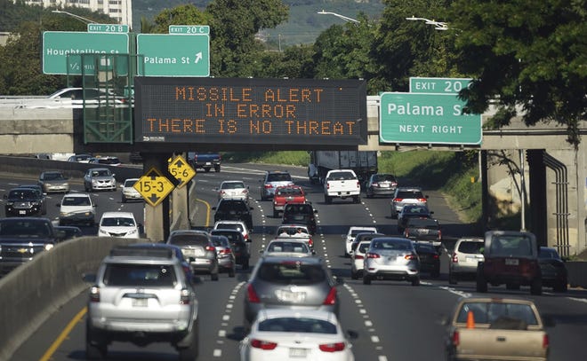 In this Saturday, Jan. 13, 2018 photo provided by Civil Beat, cars drive past a highway sign that says "MISSILE ALERT ERROR THERE IS NO THREAT" on the H-1 Freeway in Honolulu. The state emergency officials announced human error as cause for a statewide announcement of an incoming missile strike alert that was sent to mobile phones. (Anthony Quintano/Civil Beat via AP)