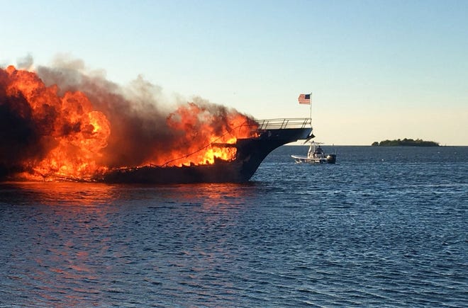 In this photo provided by Pasco County flames engulf a boat Sunday, Jan. 14, 2018, in the Tampa Bay area. The boat ferrying patrons to a casino ship off the Florida Gulf Coast caught fire near shore Sunday afternoon, and dozens of passengers and crew safely made it to land with some jumping overboard to escape, authorities said. (Pasco County Fire Rescue via AP)