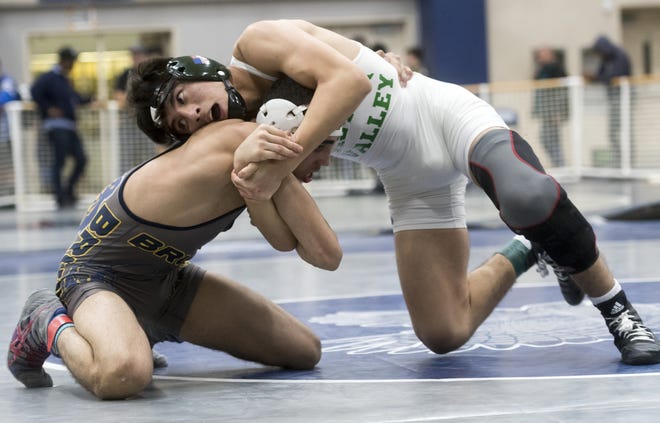 Victor Valley's Sunny Luna attempts to take down Bloomington's Mohamed Shalabi during their championship match the Adrian Amaral Memorial Tournament at Silverado on Saturday Luna took first in the 126 pound division. [James Quigg, Daily Press]