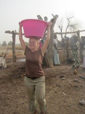 Sarah Ferguson fetches water in Senegal during her 2011-2013 stint in the Peace Corps. COURTESY OF SARAH FERGUSON