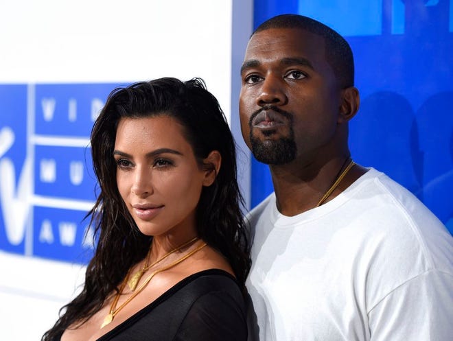In this Aug. 28, 2016 photo, Kim Kardashian West, left, and Kanye West arrive at the MTV Video Music Awards in New York. Kardashian West announced on her app Tuesday, Jan. 16, 2018. the birth of their daughter via surrogate The baby, their third, was born early Monday and weighed in at 7 pounds, 6 ounces. (Photo by Evan Agostini/Invision/AP, File)