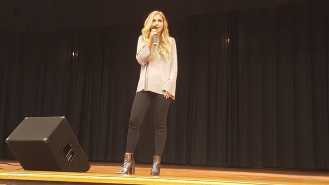 Country music artist Jessie Chris performs on stage at Waynesboro Area Middle School Tuesday morning.