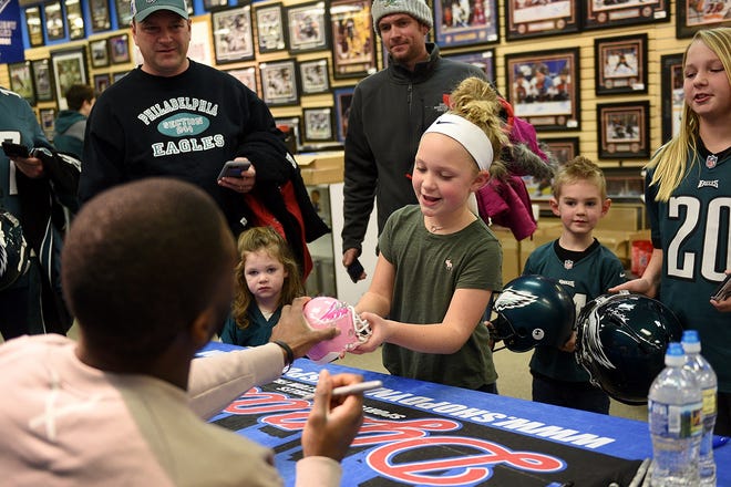 Riley Gearhart, 8, of Newtown, has a helmut signed by Eagles wide receiver Nelson Agholor at Dynasty Sports & Framing in the Oxford Valley Mall in Middletown on Tuesday, Jan. 16, 2018. Hundreds of people turned out to get an autograph by Agholor. [KIM WEIMER / STAFF PHOTOJOURNALIST]