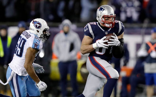 New England Patriots tight end Rob Gronkowski catches a pass in front of Tennessee Titans linebacker Wesley Woodyard in last week’s playoff game. (AP Photo/Charles Krupa)