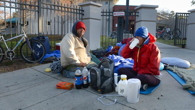 A homeless couple sit outside The Salvation Army in Sarasota in this January 2015 photo. Private donations have enabled the Gulf Coast Community Foundation and a coalition of social-service organizations to contract with a Pinellas County group to oversee a rapid-rehousing initiative in Sarasota County. [Herald-Tribune staff photo by Dan Wagner]