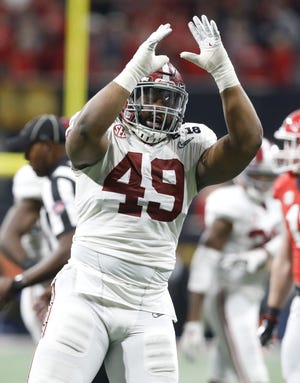 Alabama defensive lineman Isaiah Buggs (49) celebrates a tackle for a loss against Georgia during the College Football Playoff National Championship at Mercedes-Benz Stadium in Atlanta. [Staff Photo/Gary Cosby Jr.]