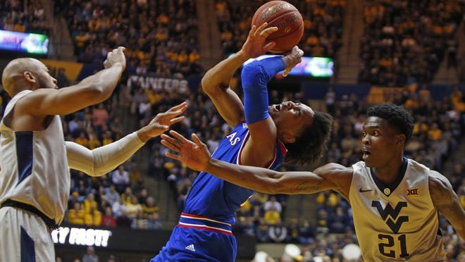Devonte’ Graham #4 of the Kansas Jayhawks drives to the rim against Wesley Harris #21 of the West Virginia Mountaineers at the WVU Coliseum on January 15, 2018 in Morgantown, West Virginia. (Photo by Justin K. Aller/Getty Images)