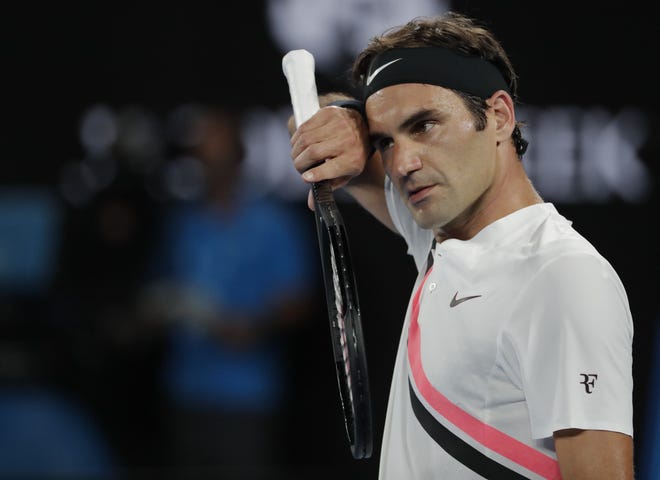 Switzerland's Roger Federer wipes sweat from his face during his second round match against Germany's Jan-Lennard Struff at the Australian Open in Melbourne, Australia, on Thursday. [AP Photo / Vincent Thian]