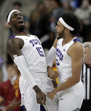 TCU forward JD Miller (15) and Shawn Olden (2) celebrate a 3-point basket by Mller in the first half of Wednesday's game against Iowa State in Fort Worth, Texas. [TONY GUTIERREZ/ASSOCIATED PRESS]
