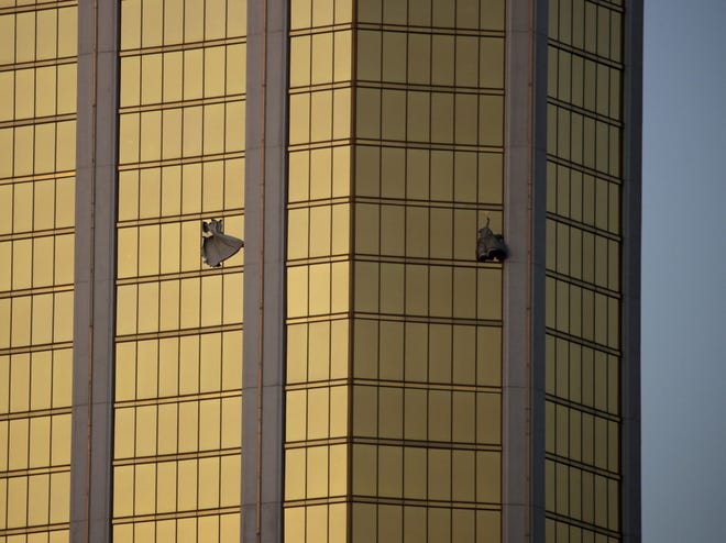 FILE - In this Monday, Oct. 2, 2017 file photo, drapes billow out of broken windows at the Mandalay Bay resort and casino on the Las Vegas Strip, following a mass shooting at a music festival in Las Vegas. A lawyer for Las Vegas police told a judge on Jan. 16, 2018, that charges could be filed in connection with the deadliest mass shooting in modern U.S. history, even though the gunman is dead. (AP Photo/John Locher, File)