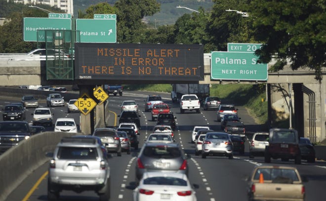 FILE - In this Saturday, Jan. 13, 2018 file photo provided by Civil Beat, cars drive past a highway sign that says "MISSILE ALERT ERROR THERE IS NO THREAT" on the H-1 Freeway in Honolulu. Gov. David Ige has appointed state Army National Guard Brig. Gen. Kenneth Hara as new head of Hawaii's emergency management agency after a faulty alert was sent to cellphones around the state warning of an incoming missile attack. (Cory Lum/Civil Beat via AP, file)