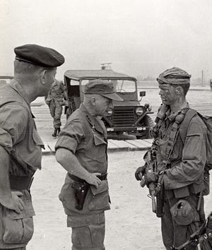 A general inspects Army Green Beret John Meyer, right, during the Vietnam war. [Provided by John Meyer]