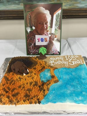 Sandy West’s birthday cake with a photo of West taken earlier this week. She couldn’t attend Thursday’s celebration. (Mary Landers/Savannah Morning News)