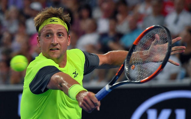 Tennys Sandgren of Tennessee hits a backhand return to Switzerland’s Stan Wawrinka during their second-round match at the Australian Open tennis championships in Melbourne, Australia on Thursday. (Andy Brownbill/AP Photo)