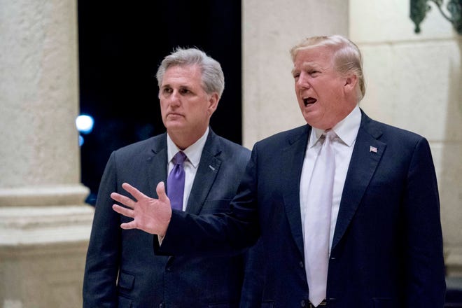 In this Jan. 14, 2018 photo, President Donald Trump, right, accompanied by House Majority Leader Kevin McCarthy, R-Calif., speaks to members of the media as they arrive for a dinner at Trump International Golf Club in West Palm Beach, Fla. Reinforcing its standing with social conservatives, the Trump administration creates a federal office to protect medical providers who refuse to participate in abortion, assisted suicide or other procedures because of their moral or religious beliefs. (AP Photo/Andrew Harnik)