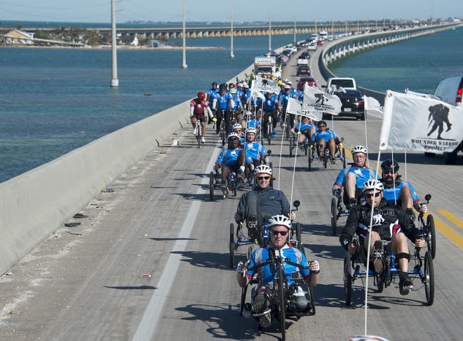 Injured military personnel ride over the Seven Mile Bridge in the Florida Keys on Jan. 5 near Marathon. [Andy Newman/Florida Keys News Bureau via AP]
