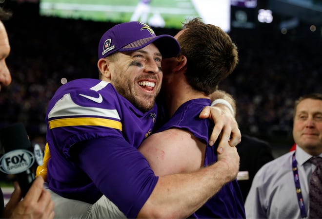 FILE - In this Jan. 14, 2018, file photo, Minnesota Vikings quarterback Case Keenum, left, celebrates after a 29-24 win over the New Orleans Saints during the second half of an NFL divisional football playoff game in Minneapolis. Keenum replaced an injured Sam Bradford, who had replaced an injured Teddy Bridgewater, all three of whom have expiring contracts after the Super Bowl. (AP Photo/Jeff Roberson, File)