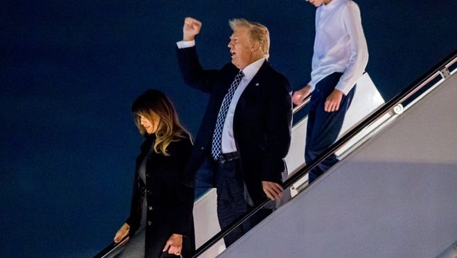 President Donald Trump, first lady Melania and their son, Barron, arrive on Air Force One at Palm Beach International Airport on Jan. 12, 2018 to spend the weekend at Mar-a-Lago. It was Trump’s 11th visit to Palm Beach in the first year of his presidency. (Richard Graulich / The Palm Beach Post)