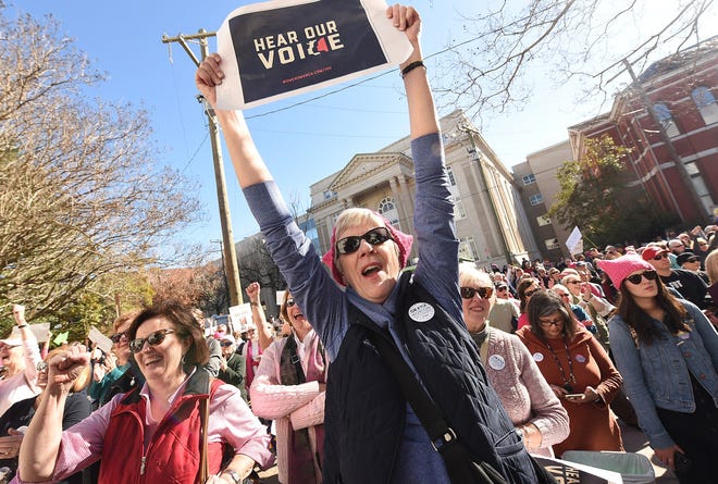 Pat Hammond holds up a Hear our Voice sign as she joined hundreds of people that gathered to listen to speakers and demonstrate along Princess Street at the Wilmington Women's March next to Wilmington City Hall in Wilmington, N.C., Saturday, Jan 20, 2018. [Ken Blevins/StarNews]