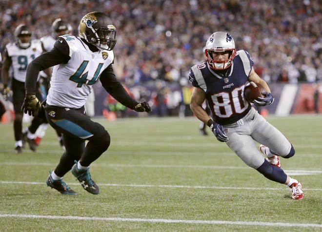 New England Patriots wide receiver Danny Amendola (80) runsto the end zone against Jacksonville Jaguars linebacker Myles Jack (44) for a touchdown after catching a pass during the second half of the AFC championship NFL football game, Sunday, Jan. 21, 2018, in Foxborough, Mass. (AP Photo/David J. Phillip)