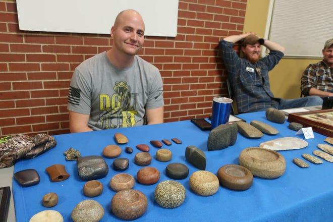 Devin Schlib of Mount Pleasant shows his collection of Native American artifacts Sunday at the Mount Pleasant Artifact Show in the Student Union at Iowa Weslyan University in Mount Pleasant. [Julia Mericle / thehawkeye.com]