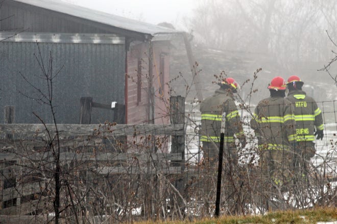 Hillsdale Township firefighters outside a barn on Mechanic Road in Hillsdale Township. COREY MURRAY PHOTO