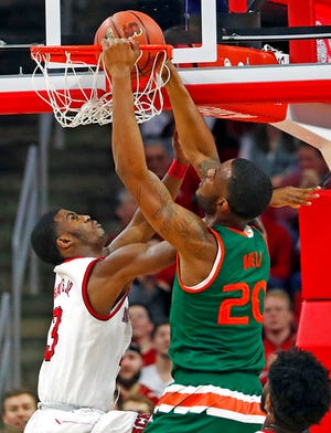 Miami's Dewan Huell (20) dunks the ball over North Carolina State's Lavar Batts Jr. (3) during the first half of an NCAA college basketball game in Raleigh, N.C., Sunday, Jan. 21, 2018. (AP Photo/Karl B DeBlaker)