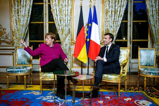 France's President Emmanuel Macron, right, and German Chancellor Angela Merkel, during their meeting, at the Elysee Palace, in Paris, Friday, Jan. 19, 2018. Meeting Friday with French President Emmanuel Macron in Paris, Merkel said she hopes the party congress will “give the green light for us to enter coalition negotiations.” (Christophe Petit Tesson, Pool via AP)
