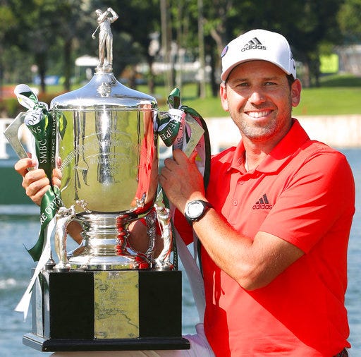 Spain's Sergio Garcia poses with his trophy after wining the Singapore Open golf tournament at the Sentosa Golf Club in Singapore Sunday, Jan. 21, 2018. Garcia shot a final round of 3-under 68 to finish at 14-under 270 and capture his 33rd professional title. (Kyodo News via AP)