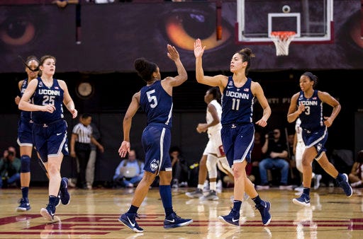 Connecticut's Kia Nurse, center right, celebrates his shot with Crystal Dangerfield, center left, during the first half of an NCAA basketball game against Temple, Sunday, Jan. 21, 2018, in Philadelphia. (AP Photo/Chris Szagola)