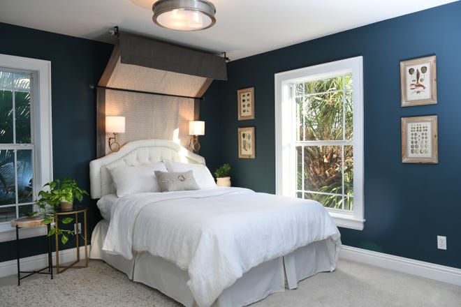 Dark walls are a trend and there are several in the two showhouses in Granada Park. In this one designers Angela Rodriguez and Sonika Fourie Dechow wrapped the room in dark blue and included a custom-designed canopy. White linens and white trim give the room a crisp and polished look. [Herald-Tribune staff photo / Mike Lang]