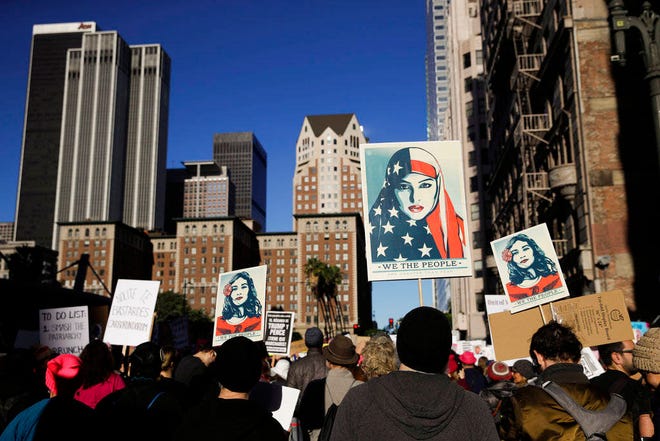 People gather for a Women’s March, Saturday, Jan. 20, 2018, in Los Angeles. On the anniversary of President Donald Trump’s inauguration, people participating in rallies and marches in the U.S. and around the world Saturday denounced his views on immigration, abortion, LGBT rights, women’s rights and more. (AP Photo/Jae C. Hong)