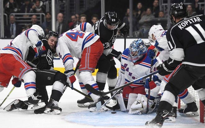 Rangers goalie Henrik Lundqvist eyes the puck during a pileup against the Kings in front of the net during the second period.
