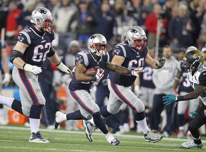 James White runs with the ball with blockers, Joe Thuney, left, and David Andrews, in the fourth quarter.  [The Providence Journal/Glenn Osmundson]