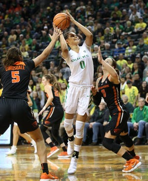 Oregon's Satou Sabally (center) shots between Oregon State's Taya Corosdale (left) and Mikayla Pivec during the first quarter. (Chris Pietsch/The Register-Guard)
