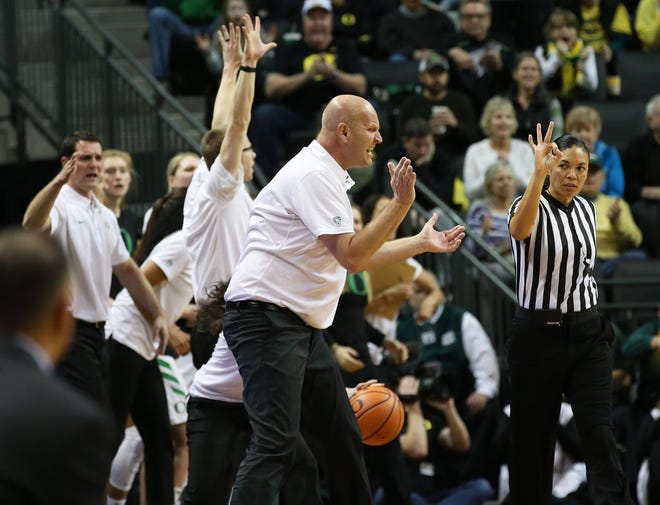 Oregon head coach Kelly Graves and the bench celebrate an Oregon State turnover during the first half. (Chris Pietsch/The Register-Guard)