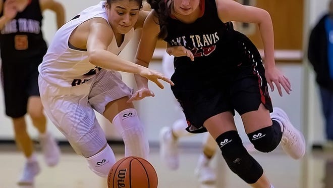Vista Ridge Rangers guard Victoria Baker (21) and Lake Travis Cavaliers guard Shelby Devin (20) battle for the loose ball during the first period at the Girls Varsity Basketball game between the Lake Travis Cavaliers and the Vista Ridge Rangers at Vista Ridge High School on Wednesday, January 17, 2018. JOHN GUTIERREZ / FOR AMERICAN-STATESMAN