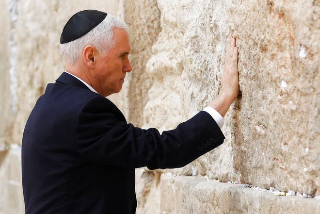 U.S. Vice President Mike Pence touches the Western Wall, Judaism’s holiest prayer site, in Jerusalem’s Old City, Tuesday, Jan. 23, 2018. (Ronen Zvulun/Pool photo via AP)