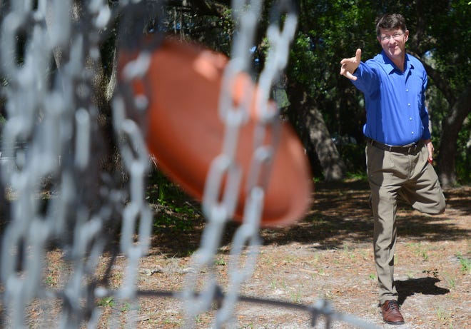 Director of the Florida Disc Golf Foundation Ben Champion demonstrates how to play disc golf at Lincoln Park in Mount Dora in May. [DAILY COMMERCIAL FILE]