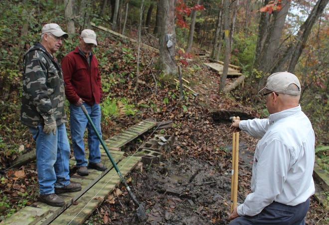 Over the Hill Gang volunteers Dave Miller, right, Duane Whitehill and Dennis Pattison work on trail maintenance at Oil Creek State Park in fall 2017. [FILE PHOTO/ERIE TIMES-NEWS]