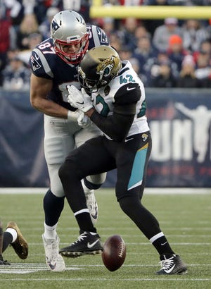 New England Patriots tight end Rob Gronkowski, left, is hit by Jacksonville Jaguars safety Barry Church, right, as he breaks up a pass during the first half of the AFC championship NFL football game, Sunday, Jan. 21, 2018, in Foxborough, Mass. AP Photo by Steven Senne