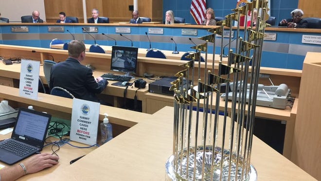 Palm Beach County commissioners get a look at the World Series trophy won by the Houston Astros, who share a spring training facility in West Palm Beach with the Washington Nationals. (Wayne Washington/The Palm Beach Post)