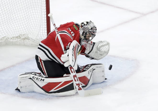 Chicago Blackhawks goaltender Jeff Glass, a former Rockford IceHog, makes a save during the second period against the Tampa Bay Lightning, Monday in Chicago. [CHARLES REX ARBOGAST/THE ASSOCIATED PRESS]