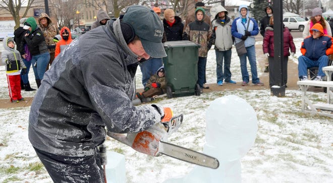Locals gathered during a past year’s Icefest to watch an ice carver create themed statues out of blocks of ice. FILE PHOTO